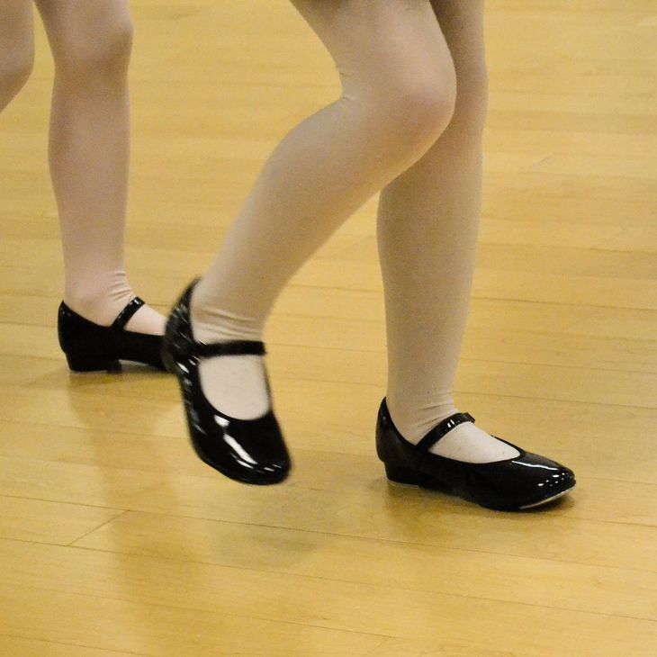 Young dancers tap shoes during a Broadway Baby tap class during their birthday party