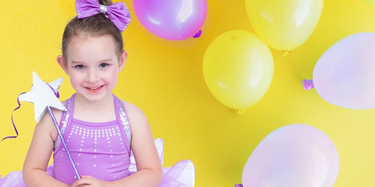 A young dancer smiling after her ballet princess birthday party