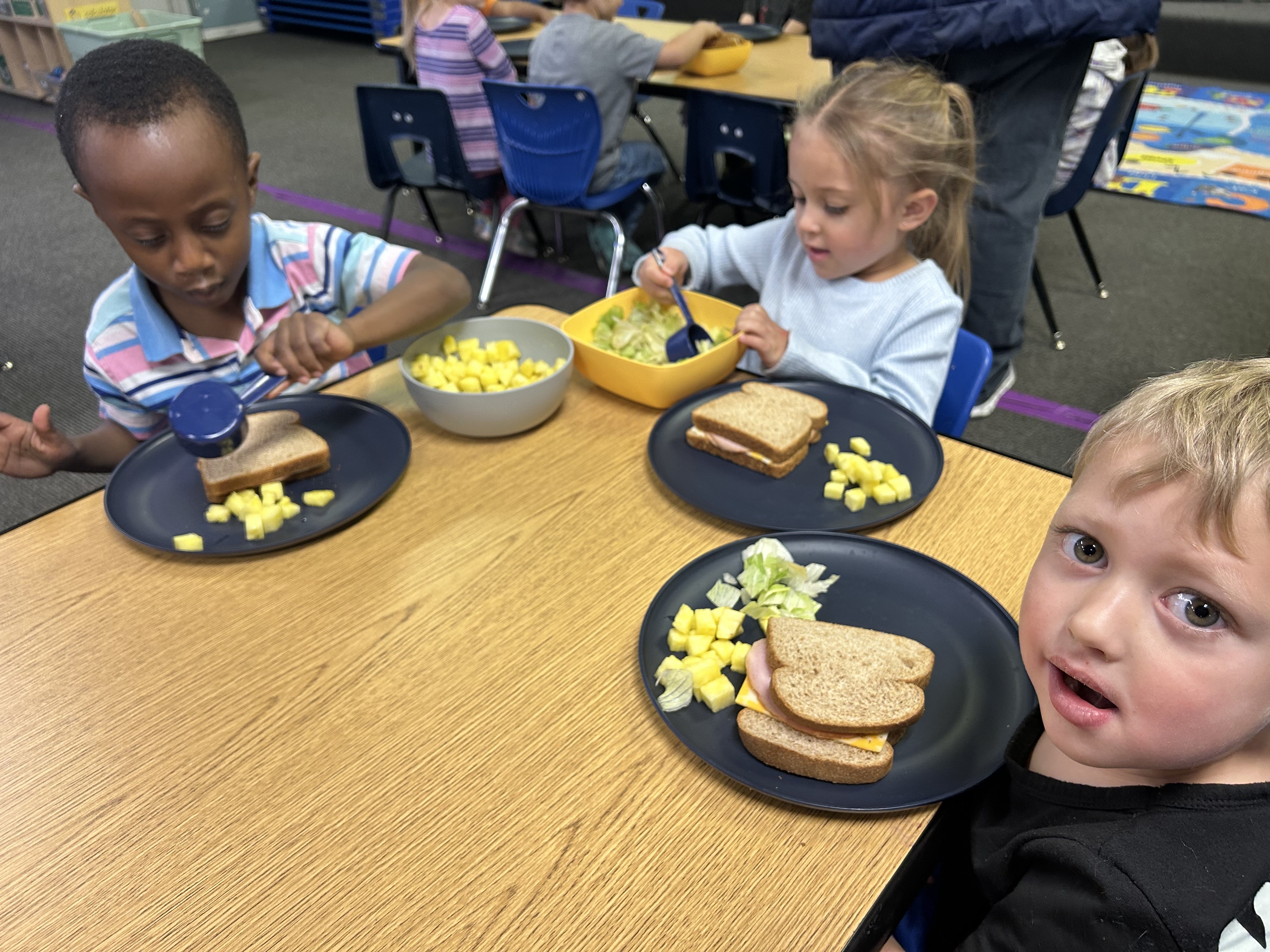 UPK serving themselves family-style at lunch