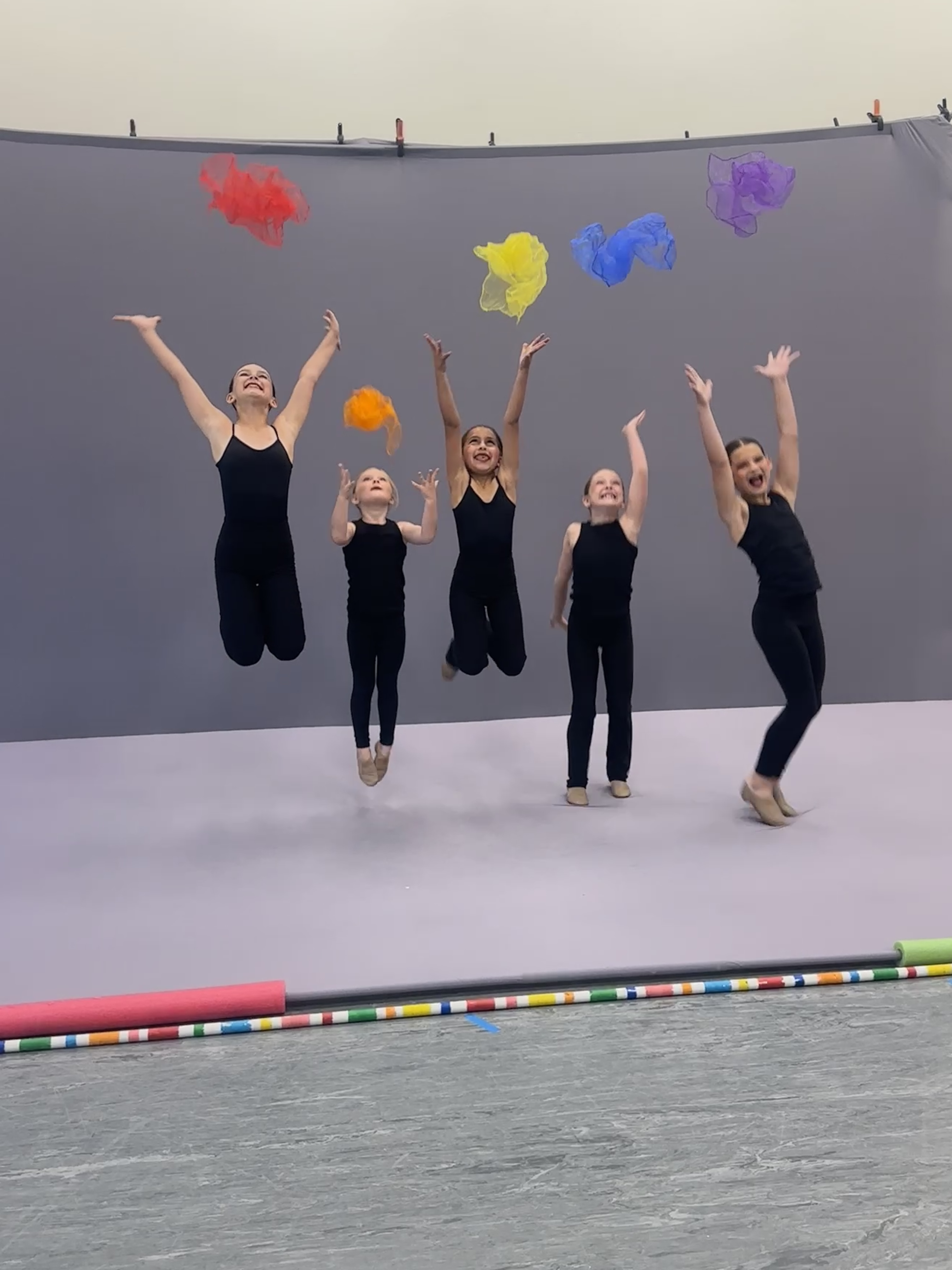 Preschoolers engaged in movement with colorful scarfs